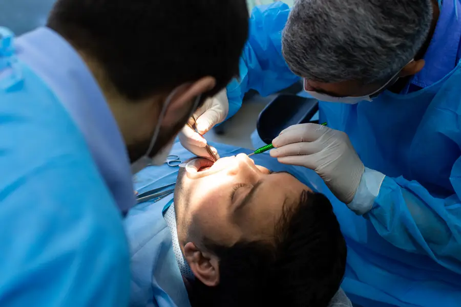Detalhe de um procedimento odontológico em andamento no dente tratado.